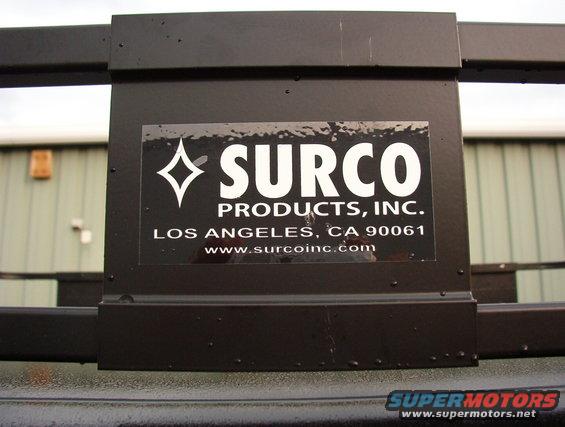 Close-up of a black metal rack with a Surco Products, Inc. sticker. Sticker says Los Angeles, CA 90061 and www.surcoinc.com