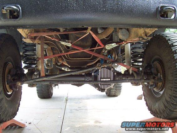 Undercarriage view of a vehicle's front axle and suspension with a black differential cover labeled 'Mag-Hytec'