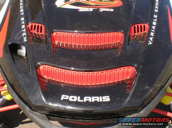 Black Polaris snowmobile hood with red vents and 'POLARIS' text
