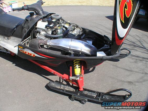 2002 Polaris 500 XC SP snowmobile with hood open showing engine and exhaust