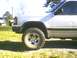 1991 Mazda Navajo - A white SUV is parked outdoors on a sunny day, with another vehicle visible in the background.