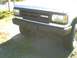 1991 Mazda Navajo - Close-up of the front grille and bumper of a white SUV, showing the Mazda emblem.