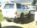 1991 Mazda Navajo - Rear view of a lifted 1991 Mazda Navajo SUV with off-road tires. A second vehicle is parked behind it.