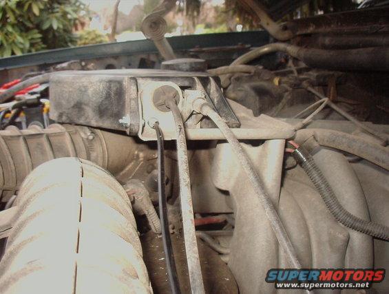 Engine bay with air intake tube and black box with wires