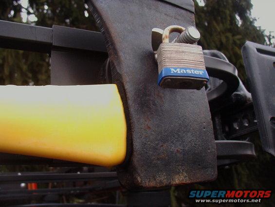 Axe head secured with a Master lock on a roof rack