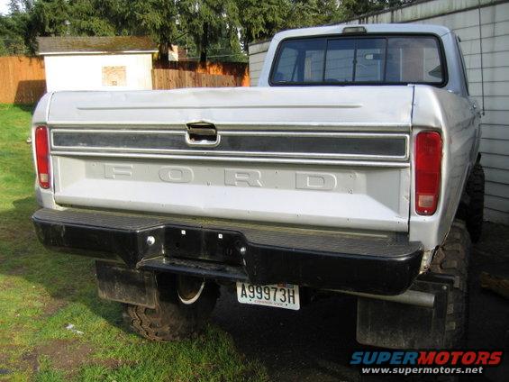 Rear of a silver Ford pickup truck, license plate A99973H