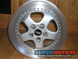 Silver five-spoke aftermarket wheel with a black center cap