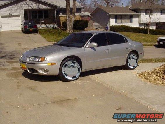 Silver sedan with chrome hubcaps parked in a driveway