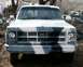 1979 Chevrolet Suburban - This GMC truck, likely from the late 1970s or early 1980s, is shown from the front with a distinctive camouflage paint job.