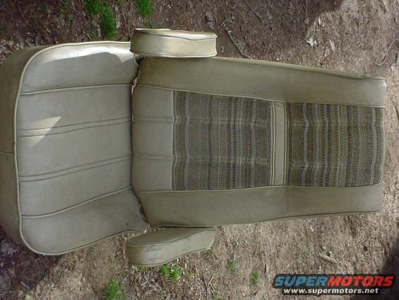 Tan car seat with striped fabric insert and headrests, lying on the ground