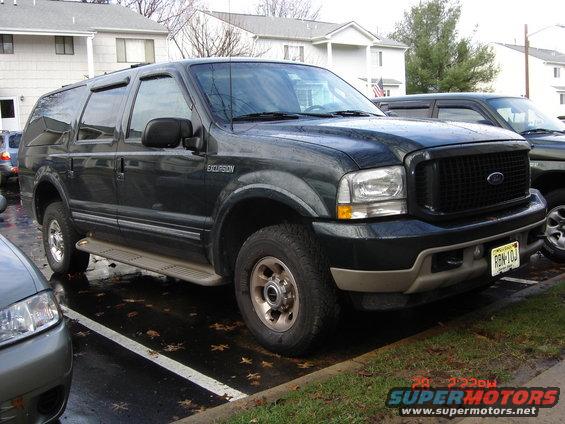 Dark green Ford Excursion parked in a lot, front quarter view. License plate REN-10J