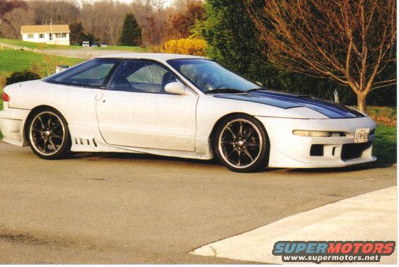 White 1995 Ford Probe with custom body kit and blue racing stripes on hood, 3/4 front view