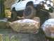 1991 Mazda Navajo - A white off-road SUV navigates a rocky terrain, its tires gripping the stones.