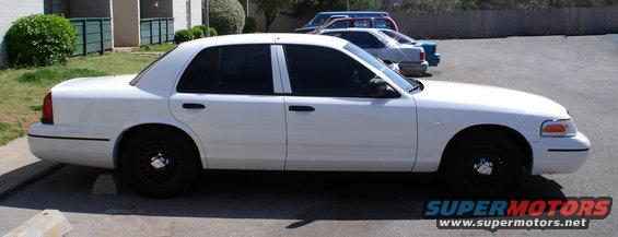 White 1998 Ford Crown Victoria, side view. Black wheels
