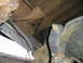 1984 Ford Bronco - Extensive rust damage is visible on the frame and suspension components of this vehicle.