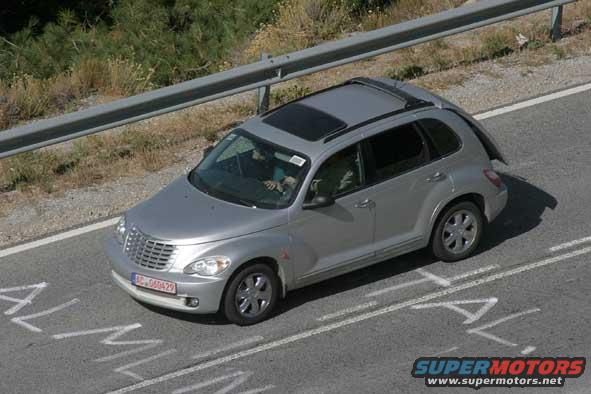 Silver Chrysler PT Cruiser driving on a road, seen from above