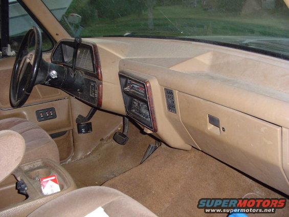 Tan interior dashboard and steering wheel of a 1989 Ford Bronco