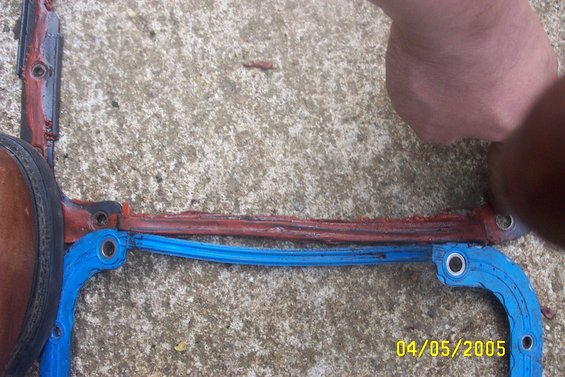 engine gasket on concrete, hand and foot visible