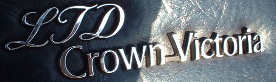 Chrome LTD and Crown Victoria emblems on a dark textured surface