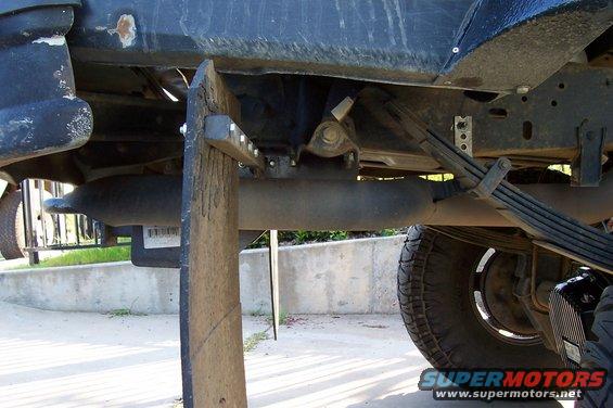Mud flap and exhaust pipe on underside of vehicle. Supermotors.net logo visible