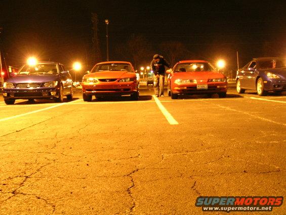 Red 1994 Ford Probe parked at night