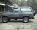 1987 Ford Bronco - This 1987 Ford Bronco is seen from the side, parked in front of a building.