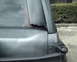 1987 Ford Bronco - Damage to the rear window frame of a vehicle is visible in this close-up shot.