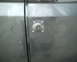 1987 Ford Bronco - Close-up of the door panel on a 1987 Ford Bronco, showing a square metal plate.
