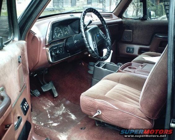 Brown velour seats and dashboard of a 1987 Ford Bronco, viewed from the passenger side