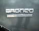 1987 Ford Bronco - Close-up of a Bronco emblem and XLT trim badge on a vehicle's body panel.
