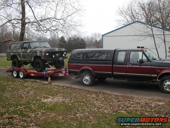 Camouflage Bronco on trailer, 3q-front view. Appears to be a 1978 model
