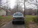 1979 Ford Bronco - A Ford F-Series truck is parked in a driveway with a house and trees in the background. Another vehicle is partially visible.