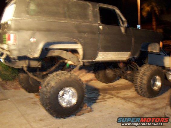 Lifted SUV with large off-road tires, appears to be undergoing modification