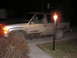 2000 Chevrolet Tahoe - This muddy 2000 Chevrolet Tahoe is seen parked at night, with its headlights on.