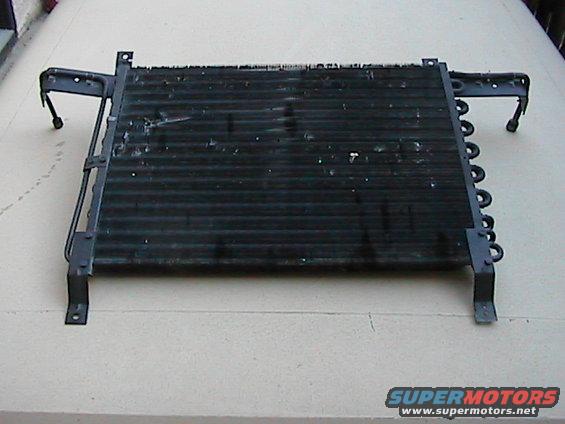 Black radiator or condenser unit with metal brackets and coiled tubes