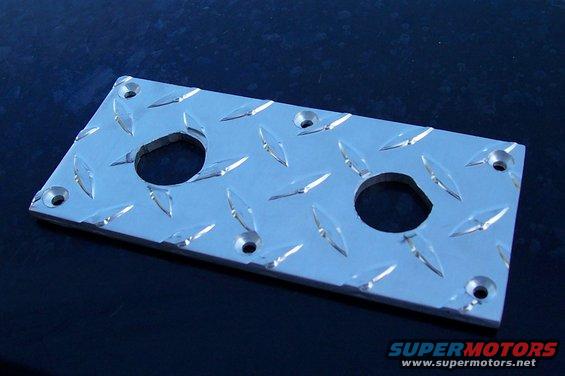 Diamond plate metal bracket with two circular cutouts and mounting holes