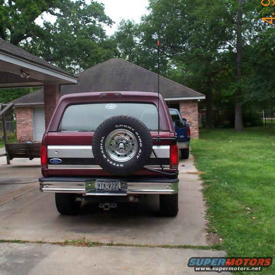 Maroon 1996 Ford Bronco rear view with spare tire and license plate 9TK-V22