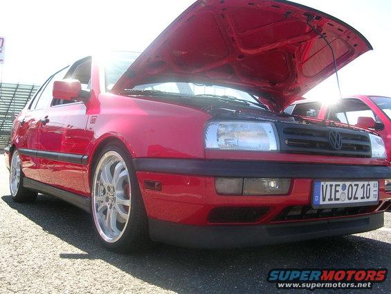 Red 1993 Volkswagen Golf with hood open, front 3/4 view