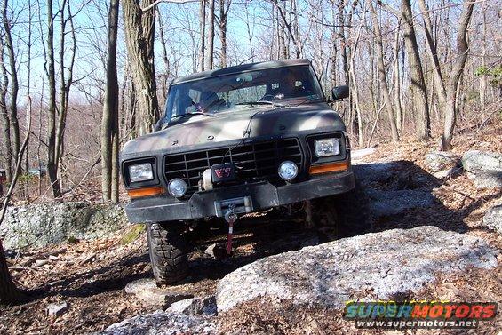 Camouflaged Ford Bronco on rocky terrain