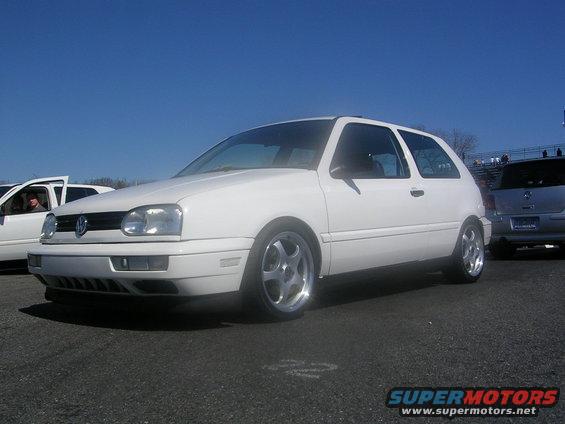 White Volkswagen Golf GTI with aftermarket wheels