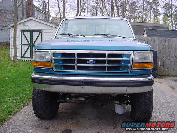 Teal 1992 Ford F-150 front view, chrome bumper, grille with Ford logo, large tires