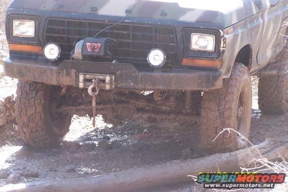 1979 Ford Bronco front with winch and off-road tires in mud