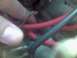1997 Ford Probe - Close-up view of automotive wiring harness with red and black cables.