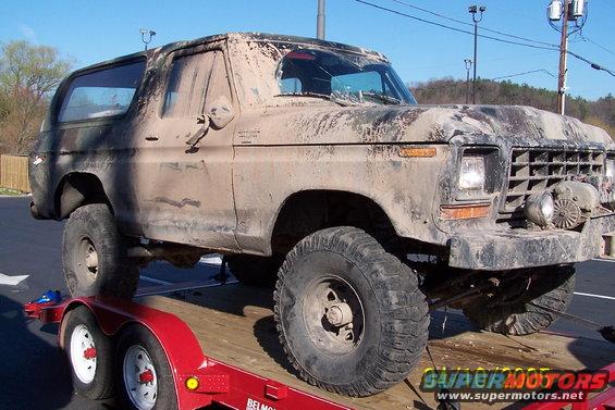 Mud-covered 1979 Ford Bronco on trailer, 3q front view