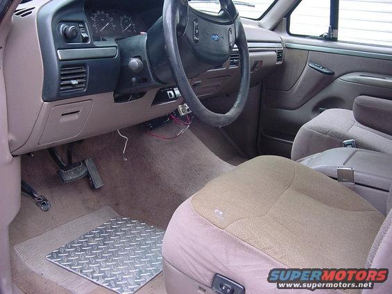 Interior shot of a 1993 Ford F-150, showing the dashboard, steering wheel, and seats