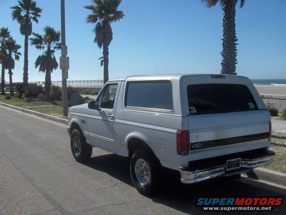 White 1995 Ford Bronco rear view parked by the beach