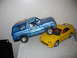 1986 Ford Bronco - Toy Bronco model is precariously balanced on top of a yellow Acura model.