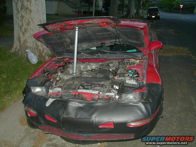 1993 Ford Probe with hood open, showing engine and front bumper cover