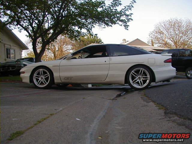 Side view of a white 1993 Ford Probe GT parked on a street