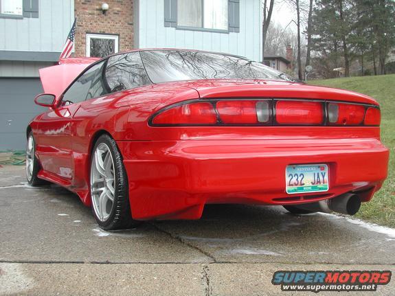 Red 1993 Ford Probe parked in driveway, hood up, with American flag visible